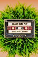 Cassette tape-shaped sign with 'Elder Emo Mix' text on a grassy background