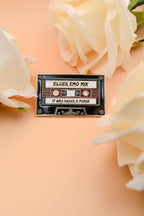 Tape cassette with 'Elder Emo Mix' text surrounded by white flowers on a peach background