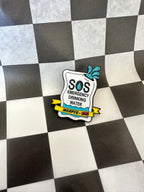 Pin with 'SOS Emergency Drinking Water' design on a checkered background