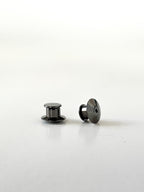 Two black locking pin backs