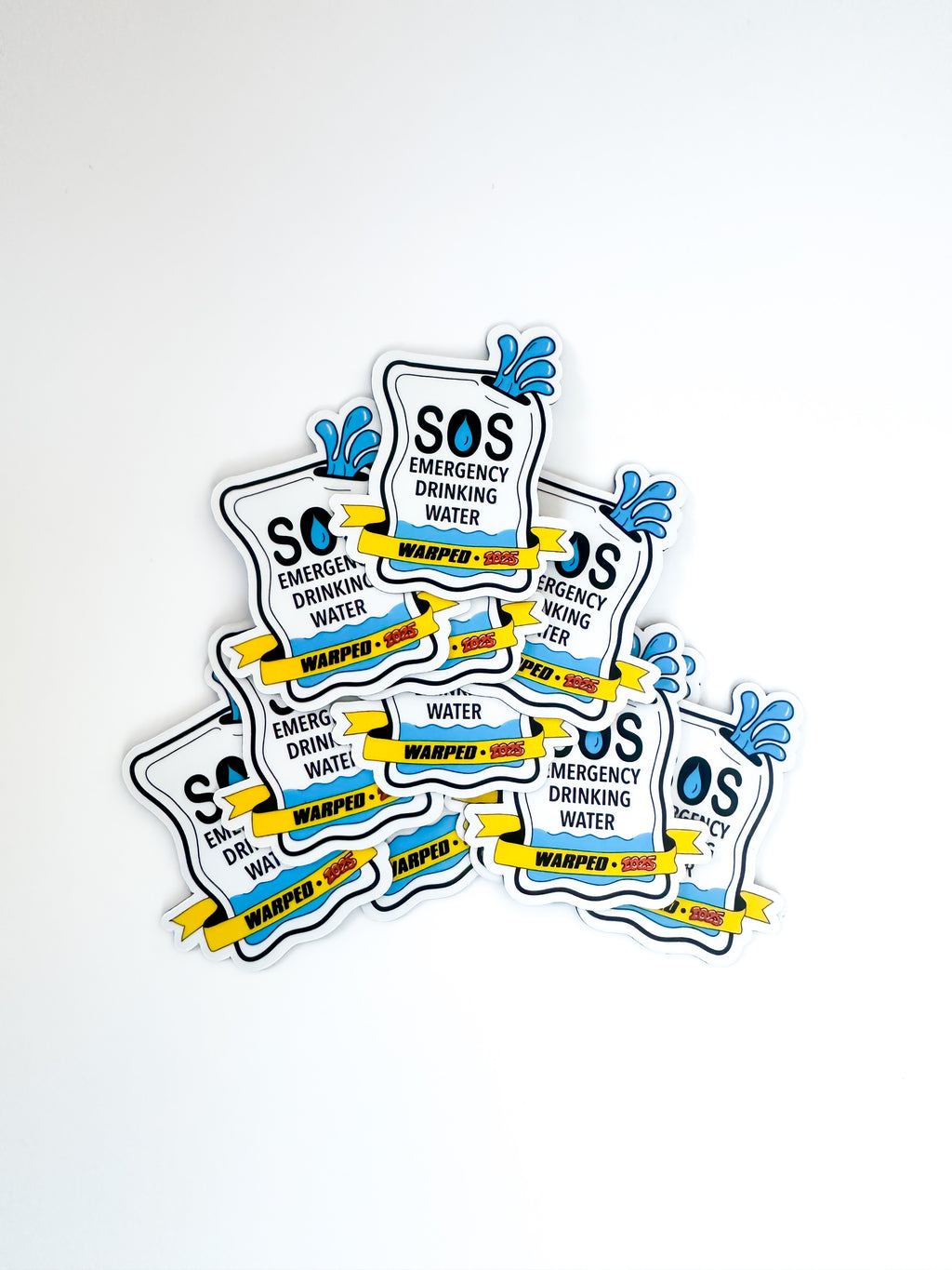 Multiple magnets with "SOS Emergency Drinking Water" on the front and a yellow banner reading "Warped 2025"
