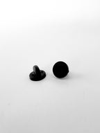 A pair of black PVC rubber pin backs