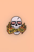 Skull with sunglass that read "Vans 2025" biting a sign that reads "Warped Tour"