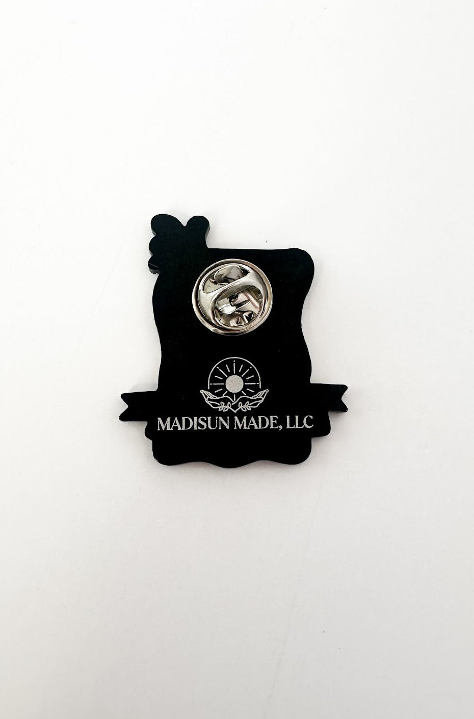 Back of enamel pin with military clutch and Madisun Made LLC logo