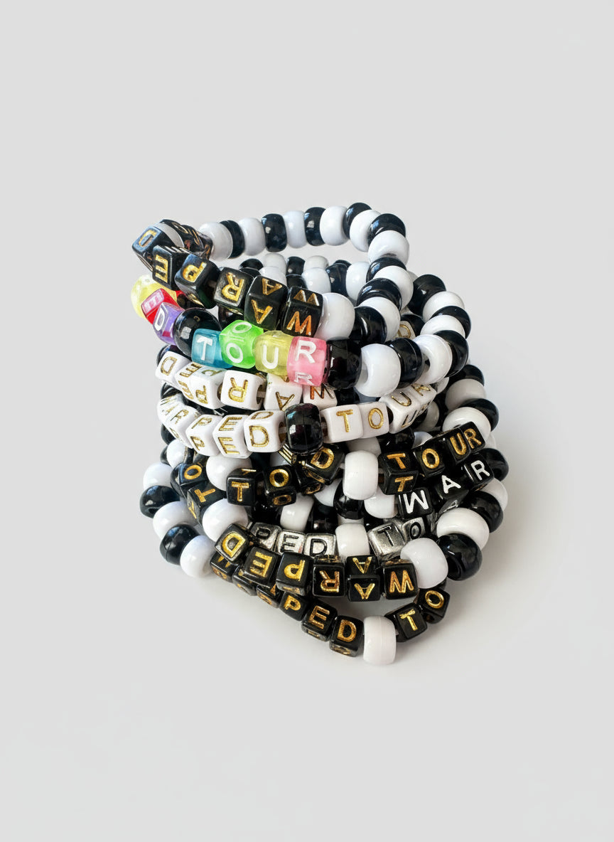 Black and white Kandi bracelets with Warped Tour text on them